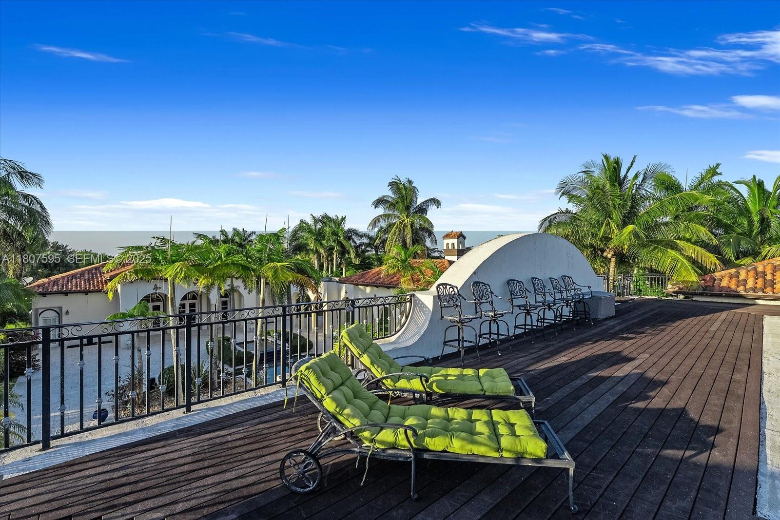 18451 Southwest 158th Street Miami, FL 33187 - Photo 35 of 45 a view of a chairs and table on the wooden roof deck