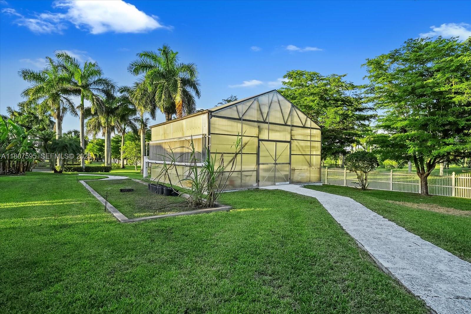 18451 Southwest 158th Street Miami, FL 33187 - Photo 36 of 45 a view of a backyard with a garden and entertaining space