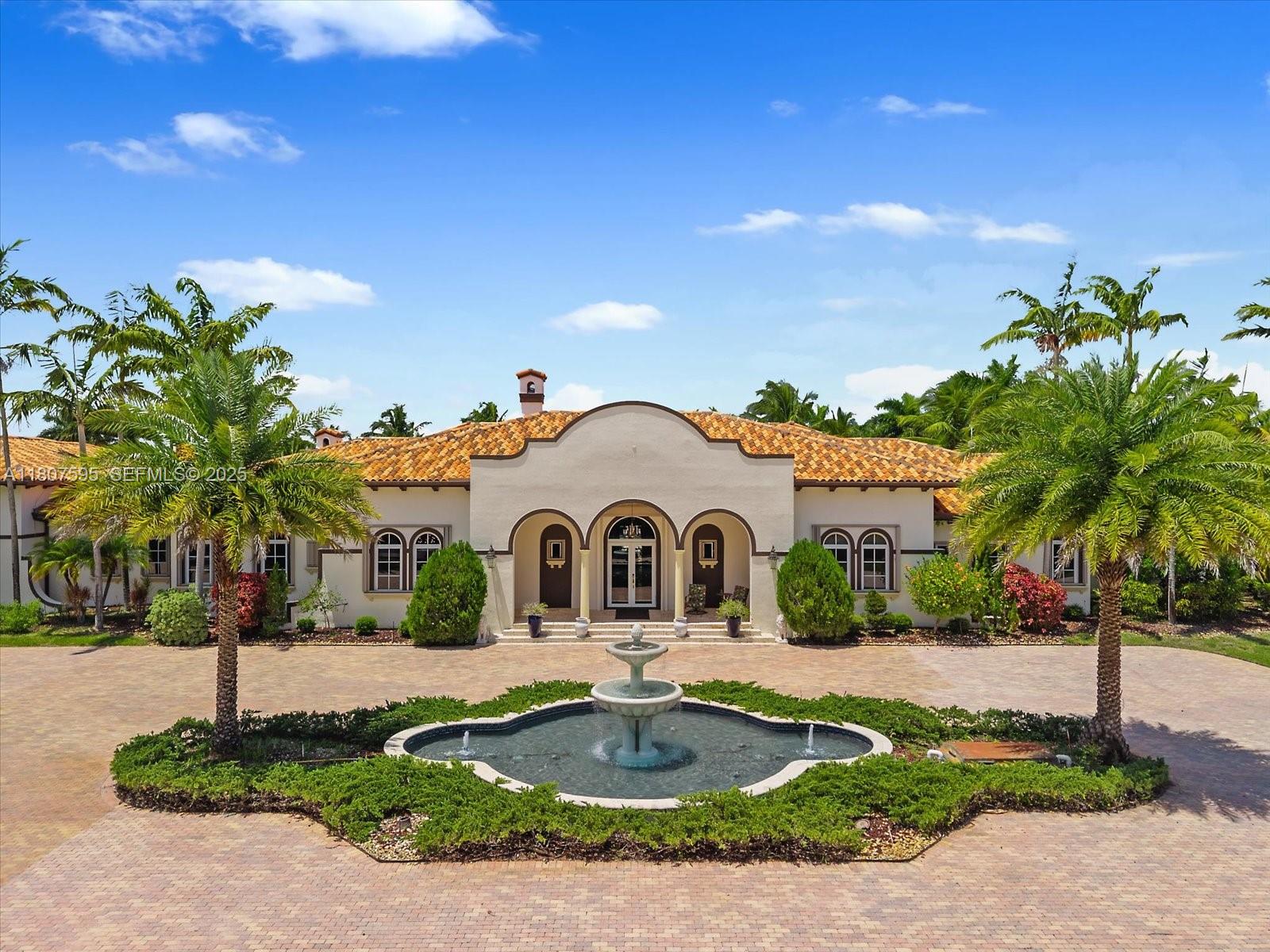 18451 Southwest 158th Street Miami, FL 33187 - Photo 7 of 45 a view of a white house with a yard