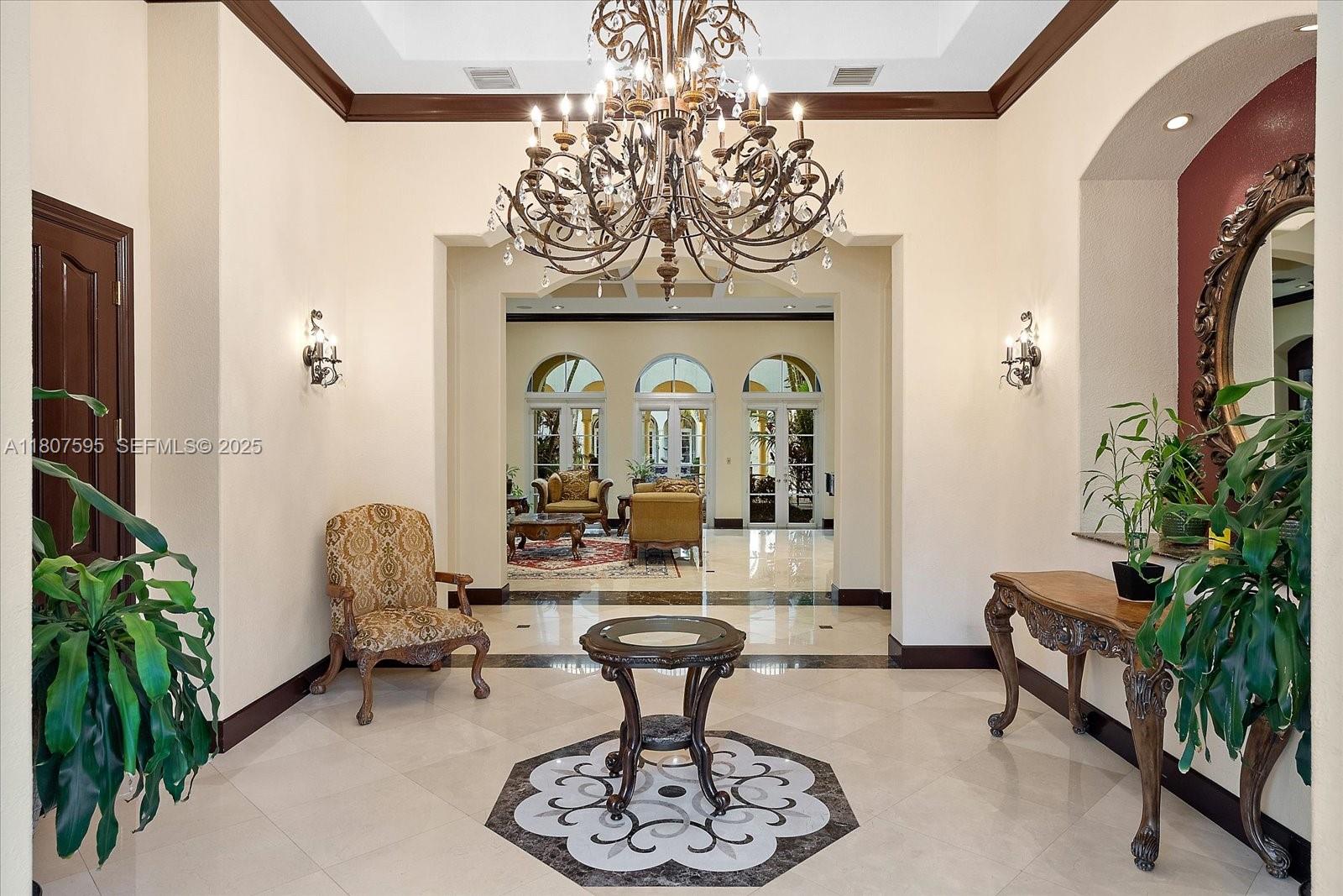 18451 Southwest 158th Street Miami, FL 33187 - Photo 9 of 45 a living room with furniture a chandelier and a chandelier