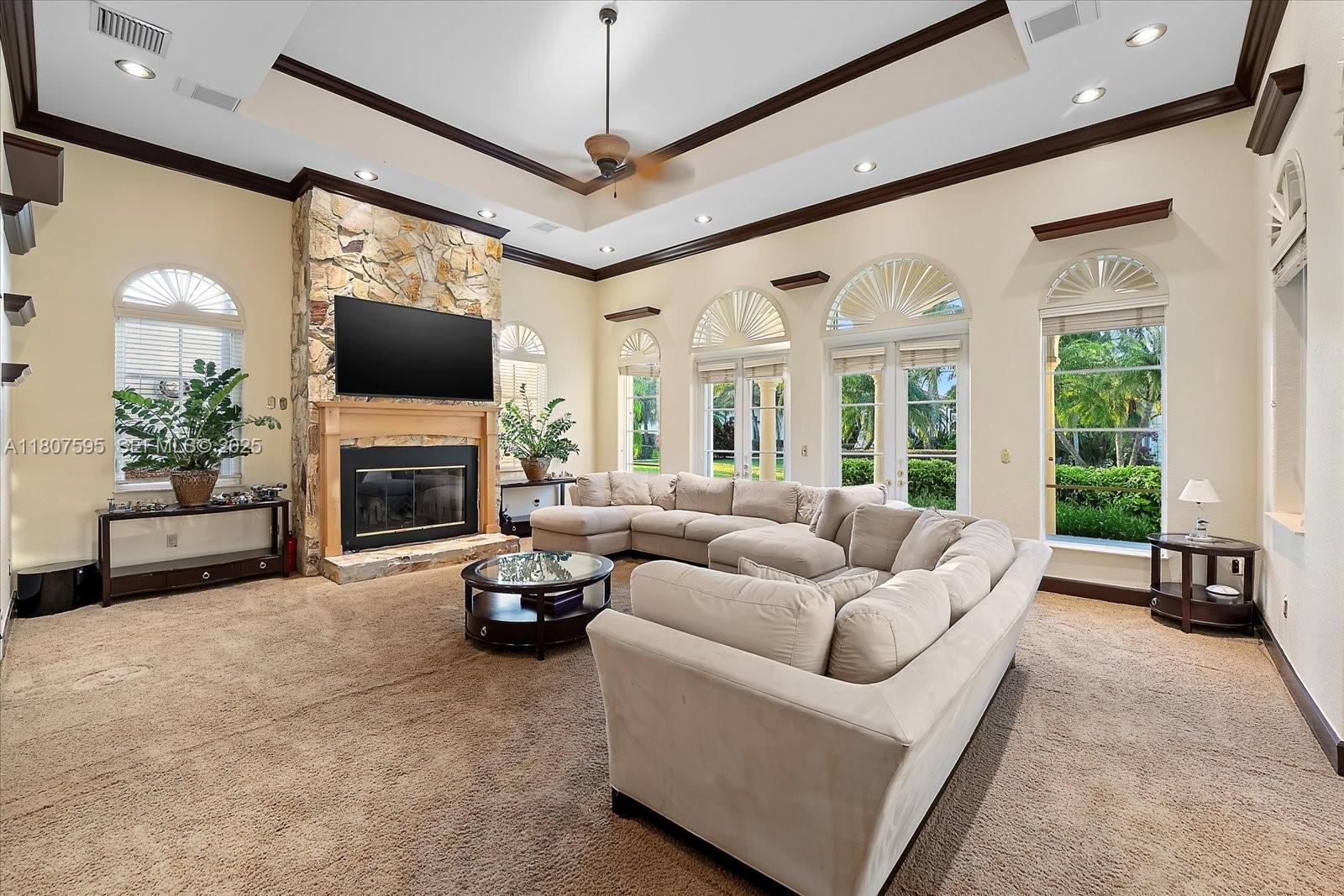 18451 Southwest 158th Street Miami, FL 33187 - Photo 10 of 45 a living room with furniture a fireplace and a flat screen tv