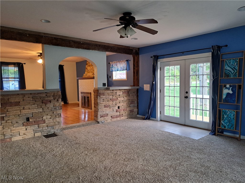 49197 John Tomcho Road Cumberland, OH 43732 - Photo 15 of 50 Living room with ceiling fan, light carpet, and french doors