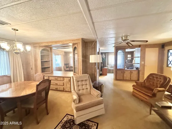 a living room with furniture a couch and large window