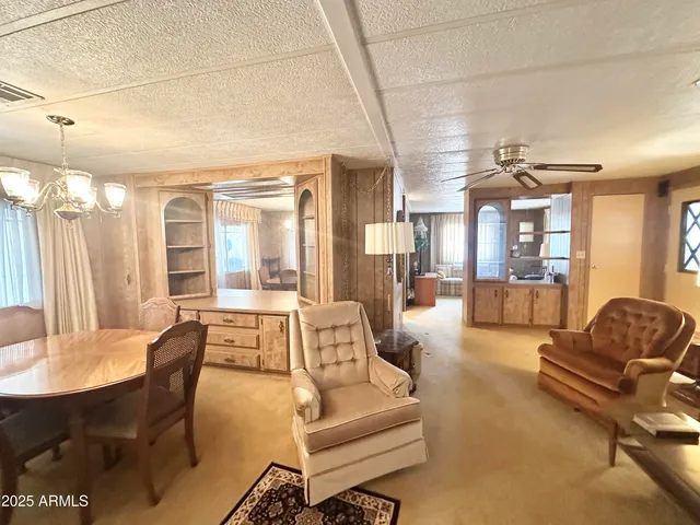 a living room with furniture a couch and large window