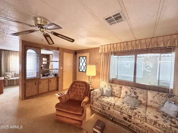 a dining room with furniture a chandelier and window