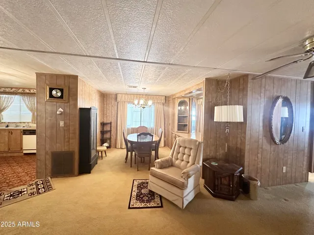 a living room with furniture a flat screen tv and a table