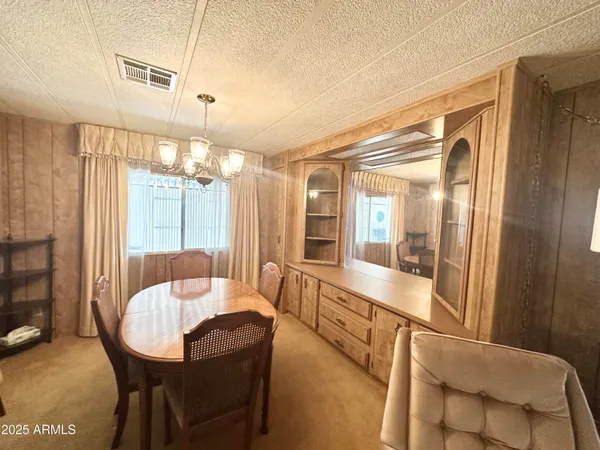 a lobby with furniture and chandelier