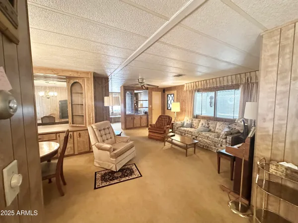 a kitchen with granite countertop a sink cabinets stainless steel appliances and a window