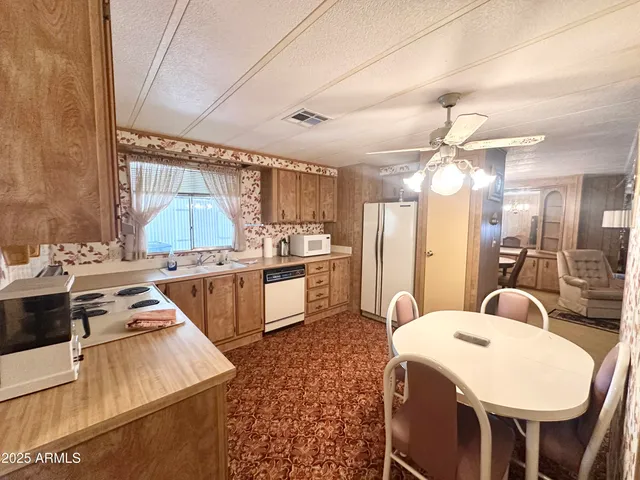 a room with a dining table chairs and entryway