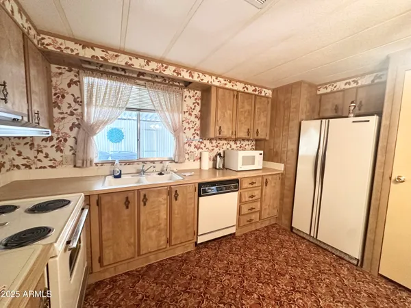 a view of a hallway with bathroom and glass door