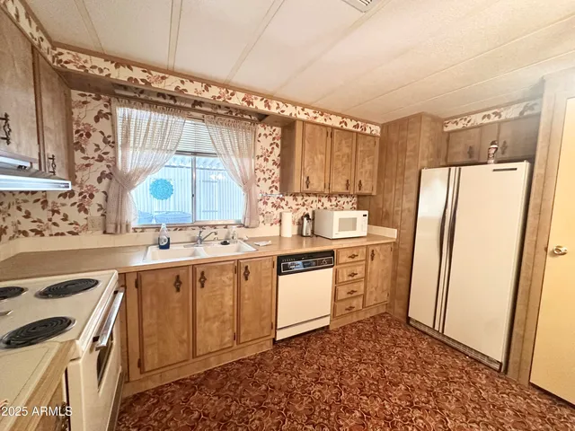 a view of a hallway with bathroom and glass door