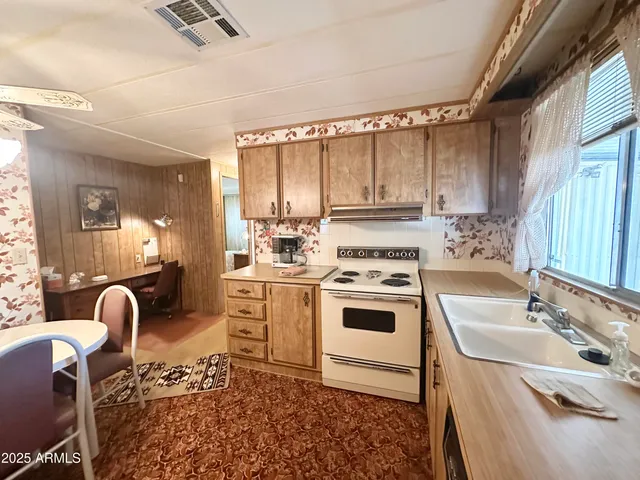 a living room with furniture and large windows