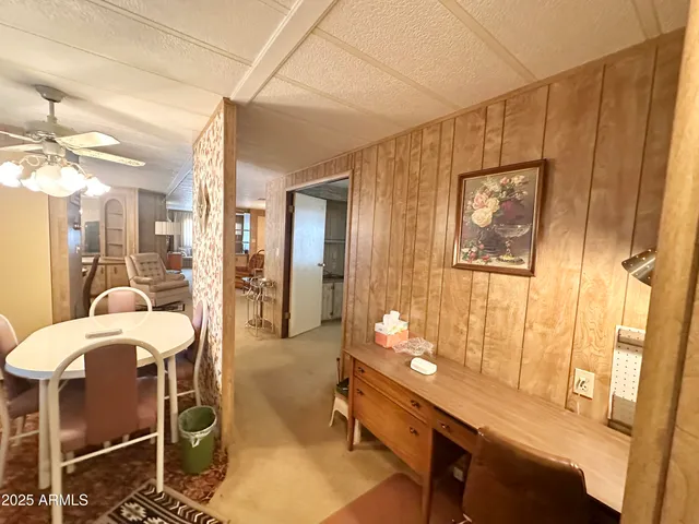 a bedroom with a bed and dresser with mirror