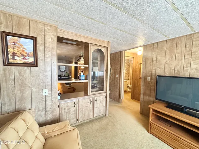 a bed sitting in a spacious bedroom next to a window