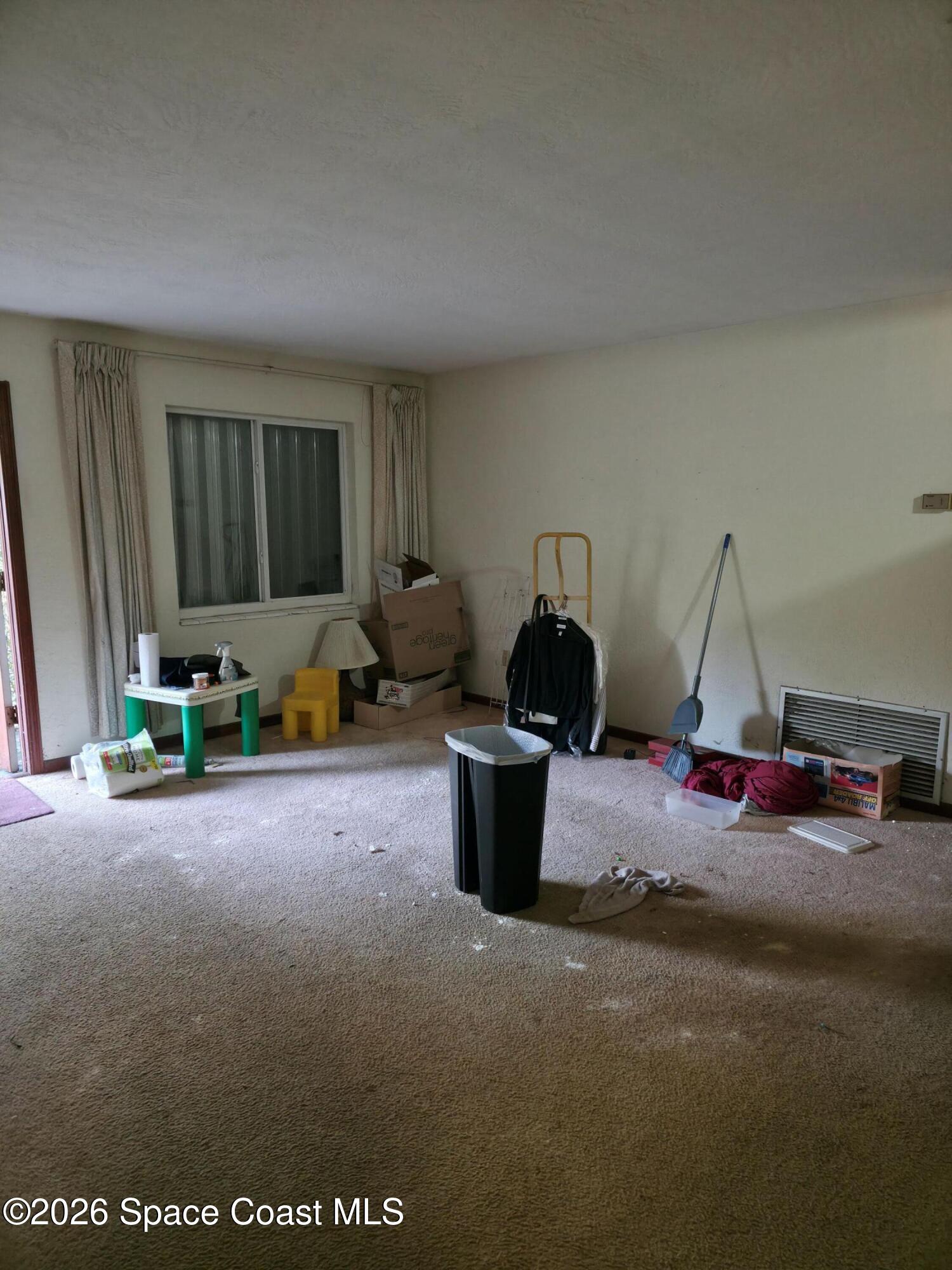 4365 Highway 1 Mims, FL 32754 - Photo 11 of 37 a living room with furniture a flat screen tv and gym equipment