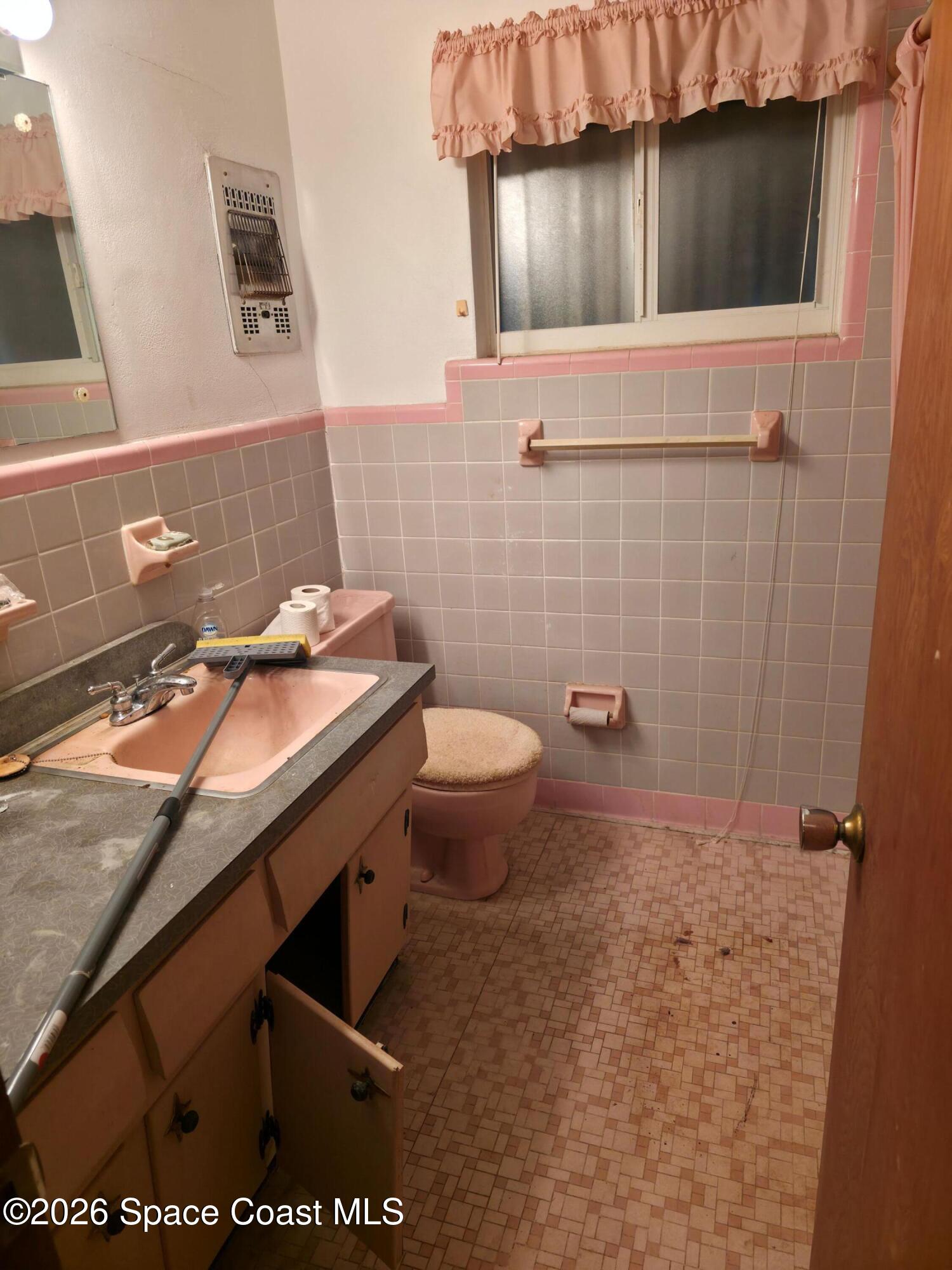 4365 Highway 1 Mims, FL 32754 - Photo 13 of 37 a bathroom with a granite countertop sink a toilet and a mirror