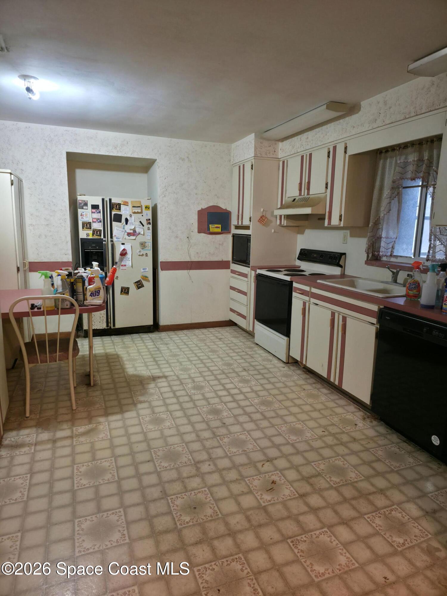 4365 Highway 1 Mims, FL 32754 - Photo 8 of 37 a large white kitchen with cabinets