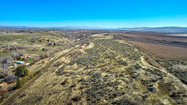 an aerial view of mountain with residential house and green space