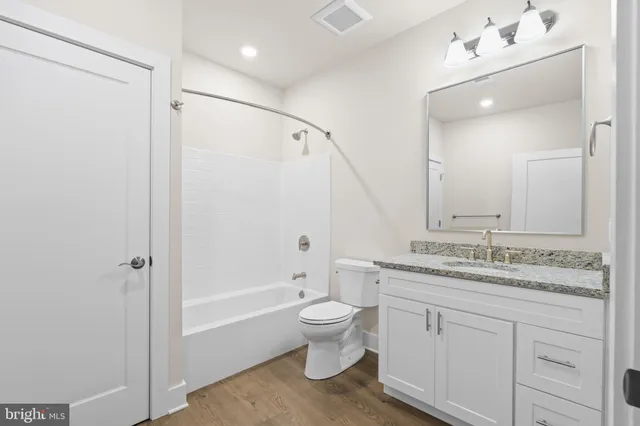 a bathroom with a sink a toilet and bathtub