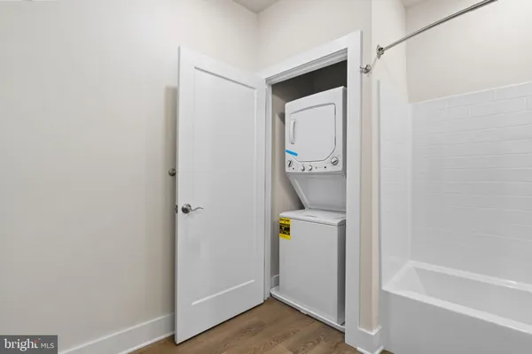 a bathroom with a granite countertop sink a toilet mirror and bathtub