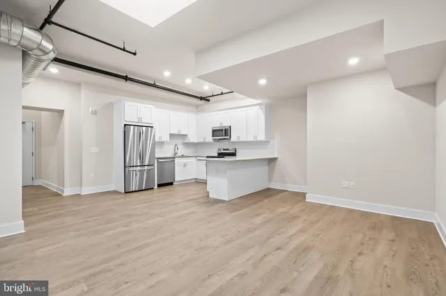 a view of kitchen with stainless steel appliances refrigerator oven and cabinets