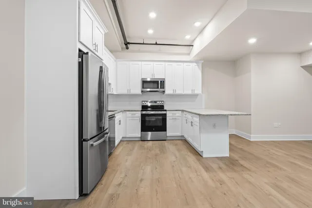 a spacious bathroom with a granite countertop sink mirror and a toilet