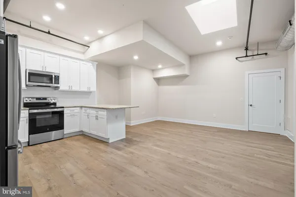 a view of kitchen with microwave and cabinets