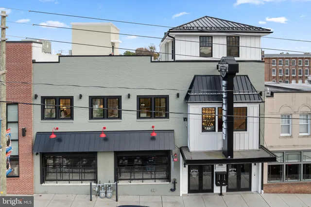 a front view of a building with parking space