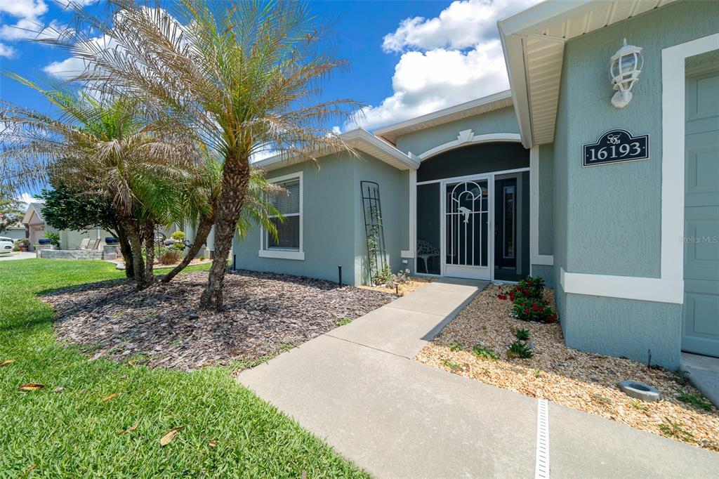 16193 Southwest 14th Avenue Road Ocala, FL 34473 - Photo 12 of 74 a front view of a house with garden