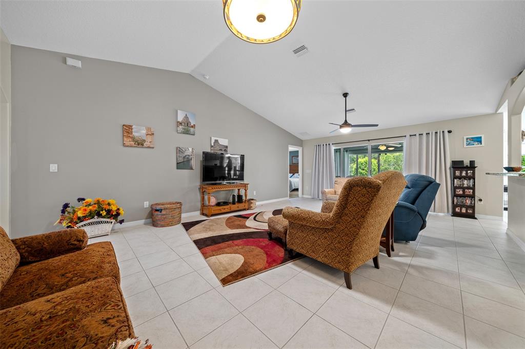 16193 Southwest 14th Avenue Road Ocala, FL 34473 - Photo 19 of 74 a living room with furniture and a chandelier