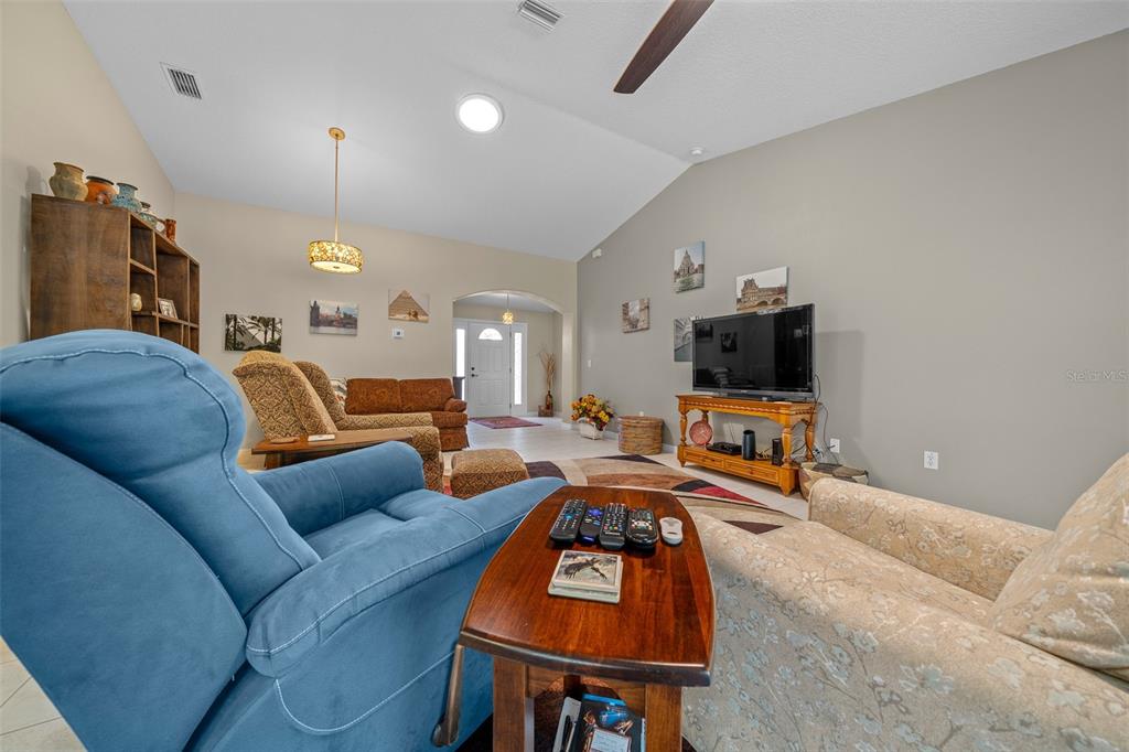 16193 Southwest 14th Avenue Road Ocala, FL 34473 - Photo 28 of 74 a living room with furniture a flat screen tv and lamp