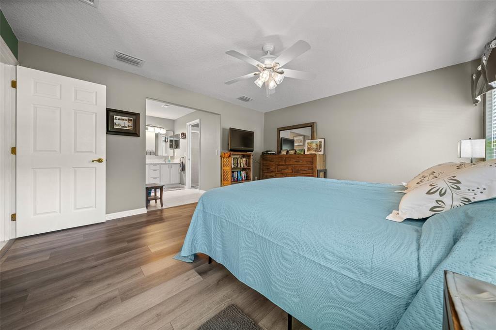 16193 Southwest 14th Avenue Road Ocala, FL 34473 - Photo 34 of 74 a bed room with a bed and a chandelier