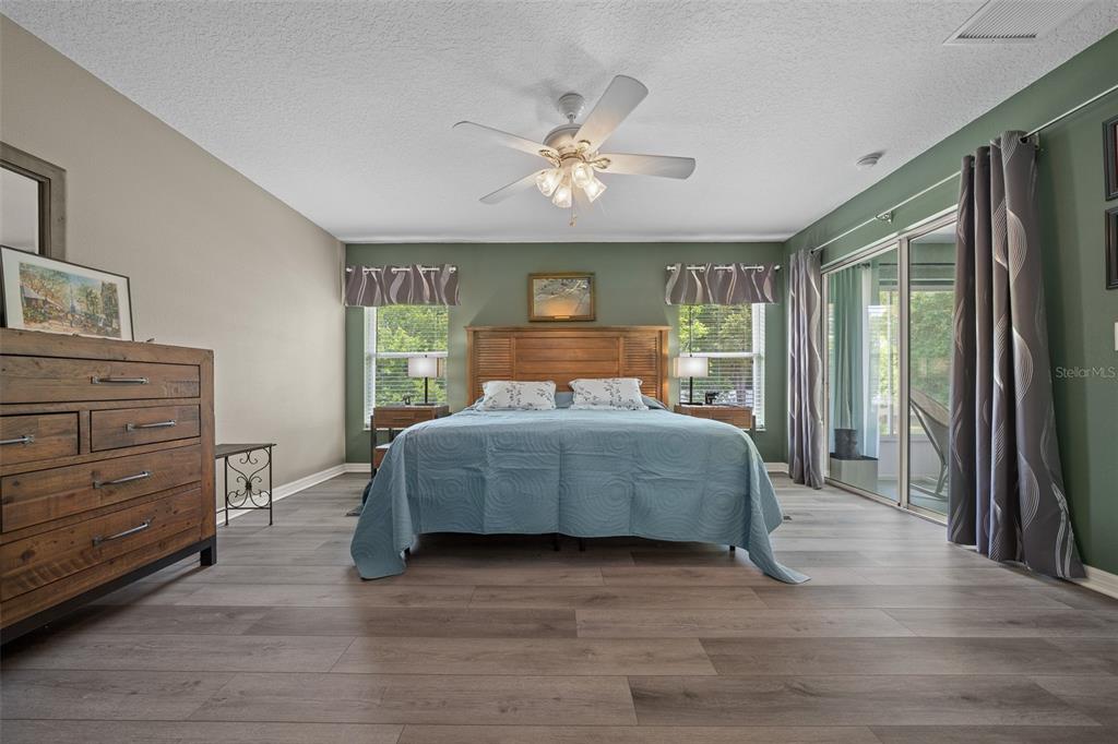 16193 Southwest 14th Avenue Road Ocala, FL 34473 - Photo 36 of 74 a bedroom with a large bed and a dresser