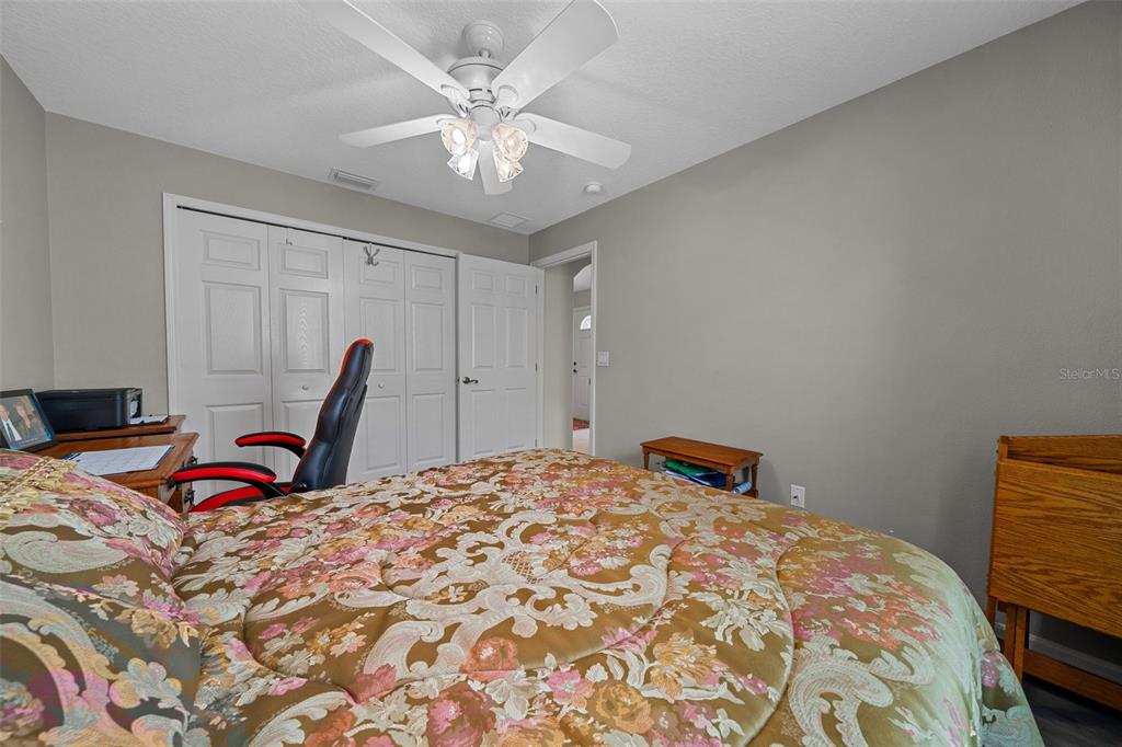 16193 Southwest 14th Avenue Road Ocala, FL 34473 - Photo 45 of 74 a bedroom with a bed and a chandelier