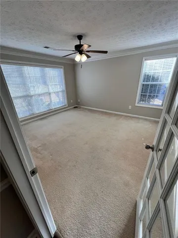 a view of a livingroom with a ceiling fan and window
