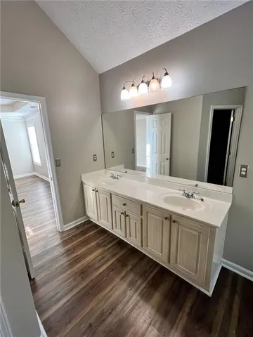 a bathroom with a double vanity sink and a mirror
