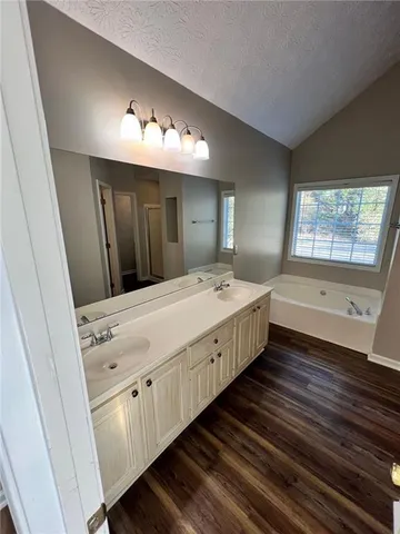 a bathroom with a double vanity sink and mirror