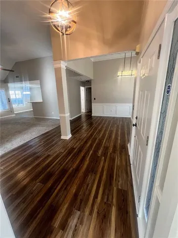 a view of a livingroom with wooden floor and staircase