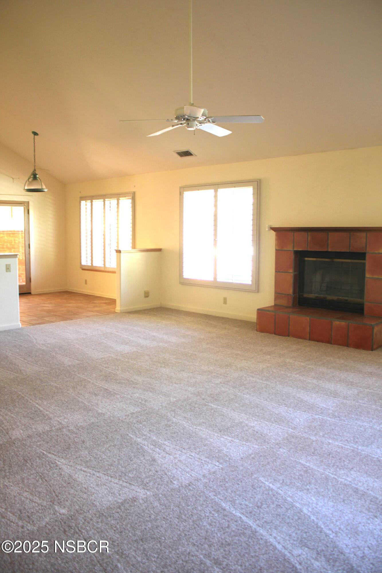 1448 Holsted Drive Solvang, CA 93463 - Photo 11 of 33 an empty room with a fireplace and windows