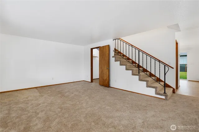a view of an empty room with stairs