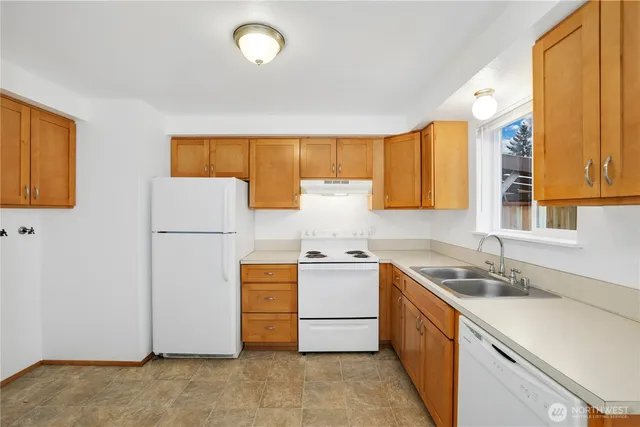 a kitchen with a sink a stove and refrigerator