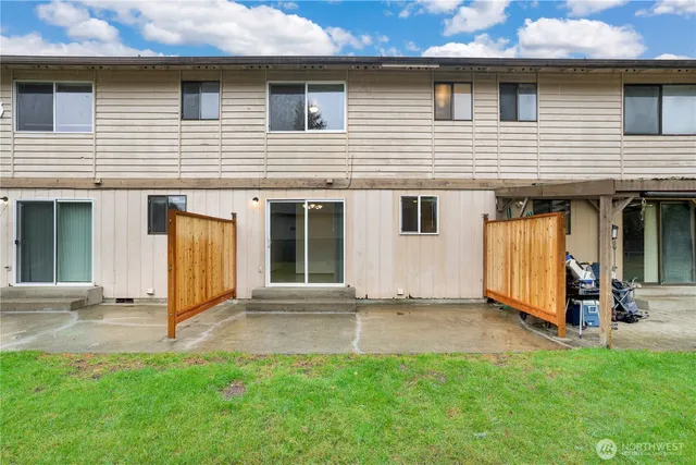 a view of a house with backyard and porch