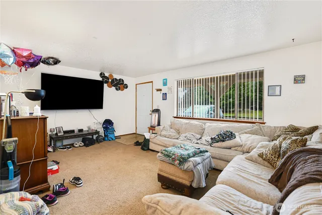 a bedroom with furniture and a flat screen tv