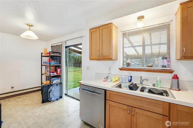 a kitchen with a refrigerator and window
