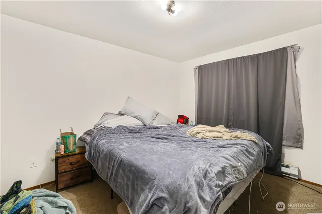 a bed sitting in a bedroom next to a cabinet