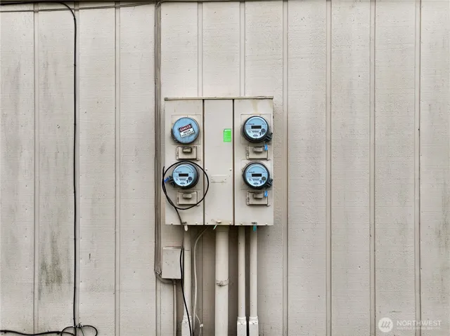 a view of a house with a big yard and large trees