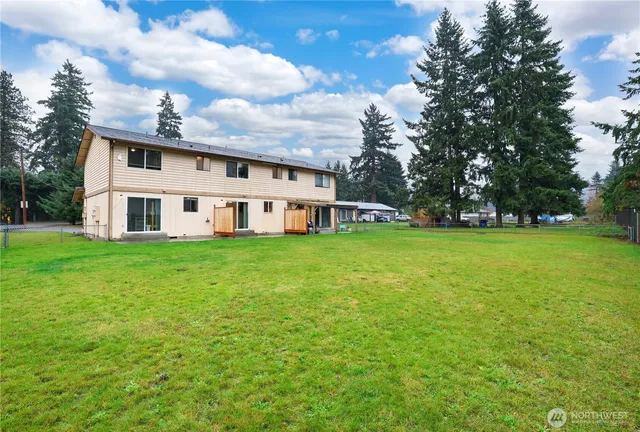 an aerial view of a house with garden space and street view