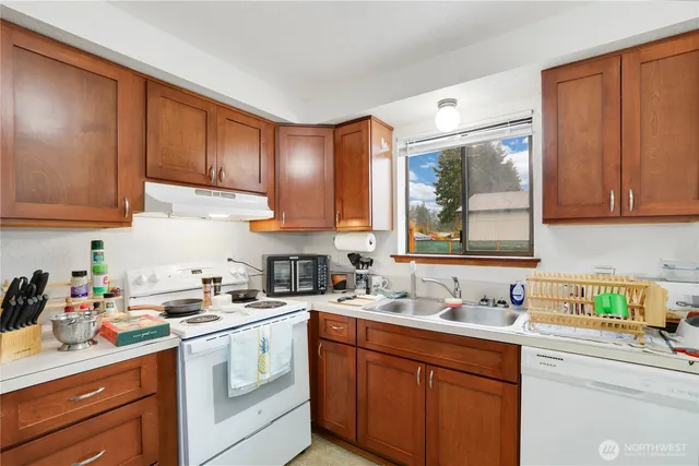a kitchen with a sink cabinets and window
