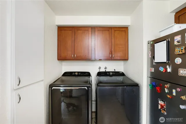 a kitchen with a refrigerator and cabinets