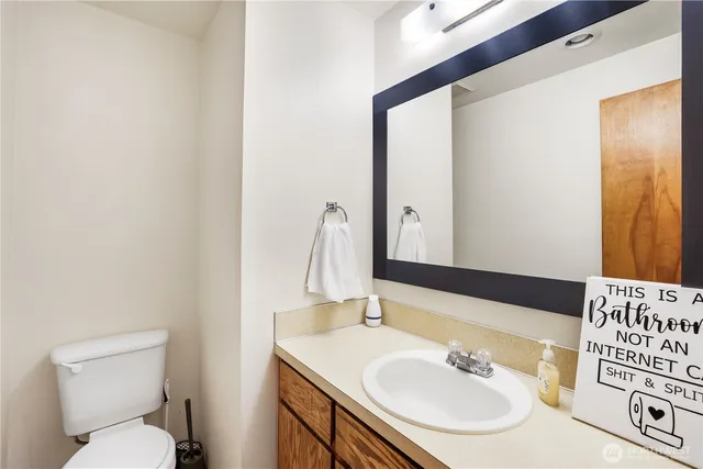 a bathroom with a sink toilet and mirror